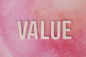 The word 'VALUE' in bold letters on a textured pink background.